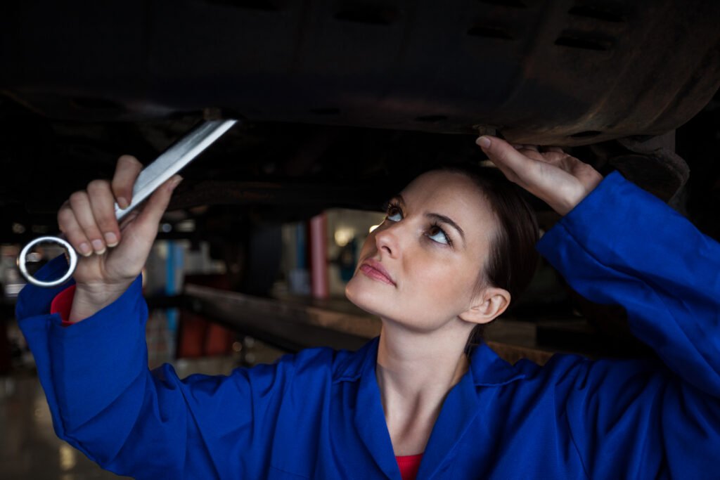 female mechanic servicing a car