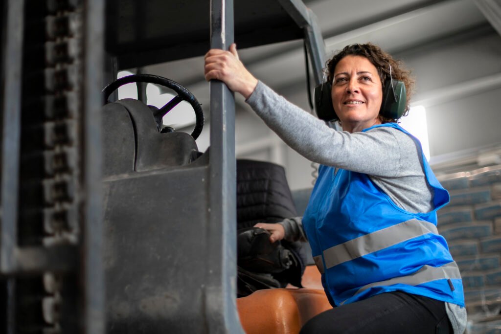 professional female driver operating forklift vehicle